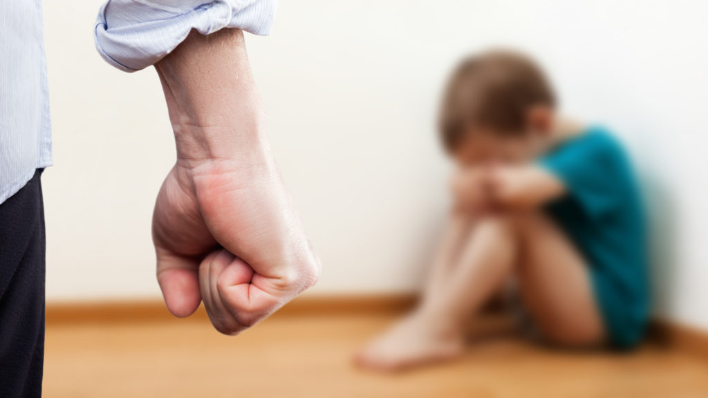 Angry man raised fist over wall corner sitting child boy